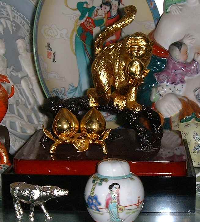 Golden Monkey holding a peach symbolises longeivity